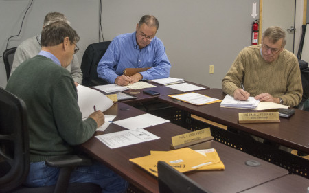 County Commissioners discuss inevitable wage increases in the Sheriff's Department during their Nov. 16, 2016 meeting in Caribou's Emergency Management Agency building. From left, around the table, Presque Isle Commissioner Paul Underwood, Houlton Commissioner Paul Adams, County Administrator Douglas Beaulieu, and Wallagrass Commissioner Norman Fournier. Christopher Bouchard | Aroostook Republican)
