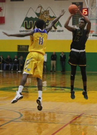UMPI forward Ebby Kamara attempts to block a shot by UMFK forward Travis Harlin during the Bengals home opener basketball game at the UMFK Sport Center on Monday, Nov. 28, 2016 in Fort Kent. Jessica Potila | SJVT / FhF)