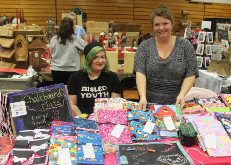 Journalist and artist Tory Jones (right) returned to Fort Kent, along with her daughter Sarah Bonenfant, to sell homemade chalk mats, jewelry and braided ribbon barrettes at the Fort Kent Arts Craft Fair during the weekend of November 26-27, 2016. Jessica Potila | SJVT / FhF)