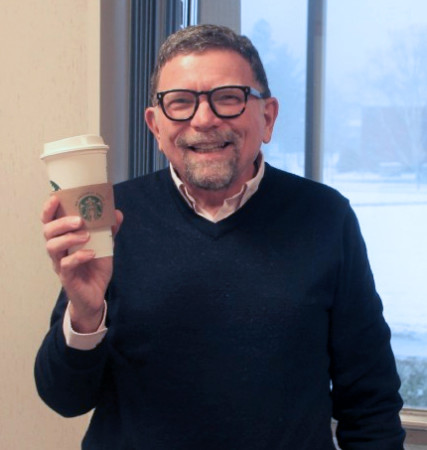 University of Maine at Fort Kent President John Short, who describes Starbucks as "an experience" enjoys a Starbucks coffee in his office on Tuesday, Nov. 29, 2016. (Jessica Potila | SJVT / FhF)