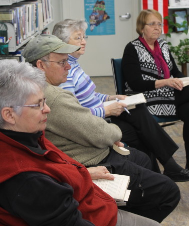Avid readers, from left, Terry "T.O." Ouellette, James Chasse, Jackie Ayotte and Maine Humanities Council scholar Jan Grieco discuss the "Let's Talk About it" book club offering, Saturday, Feb. 11 at the Long Lake Public Library in St. Agatha. (Don Eno | SJVT/FhF)