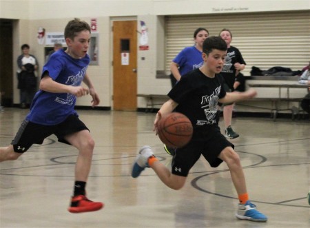 Fort Kent Magic player Keegan Cyr is hot on the heels of the Spurs' Pierson Caron in search of a steal at a Parks and Recreation Department Round Robin tournament on Thursday, March 9. (Jessica Potila | SJVT/FhF)