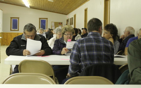 Residents at Frenchville's annual town meeting, Tuesday, March 21, look over proposed ordinance language prior to the start of the meeting. Don Eno | SJVT/FhF)