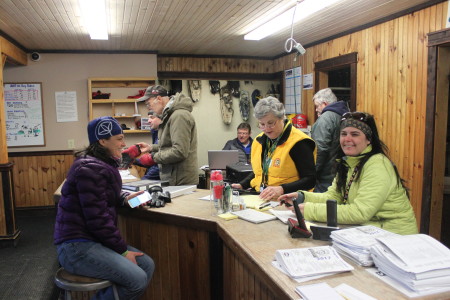 Volunteers Sylvia Dow-Harvey, left, Frances LaBrie, center, and Tonya Michaud work with checkpoint staff out on the route while at Can-Am headquarters at Lonesome Pine Trails lodge. (SJVT/FhF photo | Don Eno)
