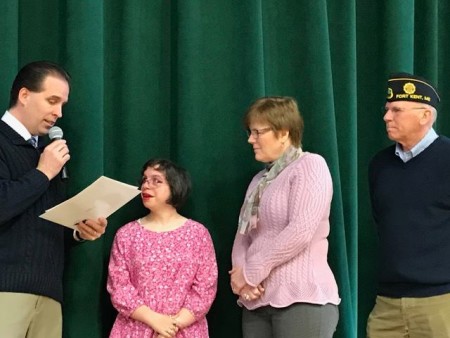 Principal James Charette presents Fort Kent Community High School student Sophie Saunders with a President's Volunteer Service Award at a special assembly at the school on Monday, March 6. From left: Jay Charette, Sophie Saunders, Kelly Martin, George Dumond. (Staff photo | Jessica Potila)