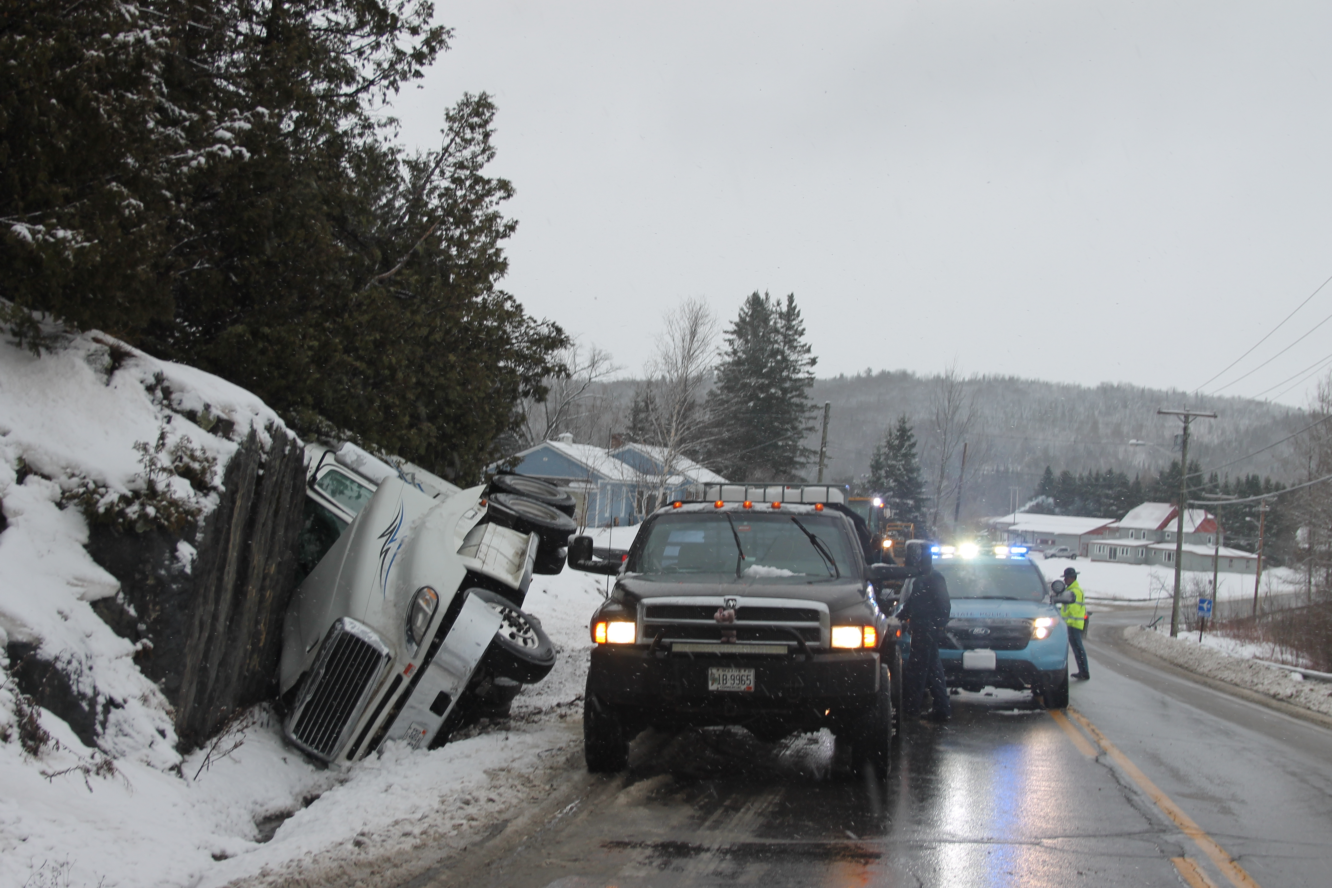 Tractor trailer catches fire after rolling over into ditch in